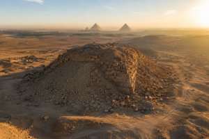 Aerial view of the ruined Djedefre pyramid at Abu Rawash with the Giza pyramids on the horizon