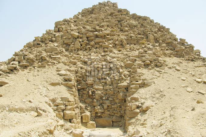 Stone ruins and entrance passage of a weathered pyramid from Egypt’s 5th Dynasty