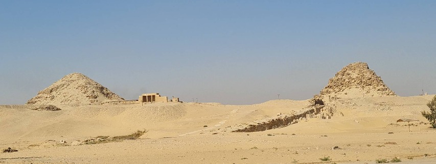 Wide-angle view of two 5th Dynasty pyramids at Abusir, showcasing the ruined yet powerful legacy of Sahure and Niuserre.