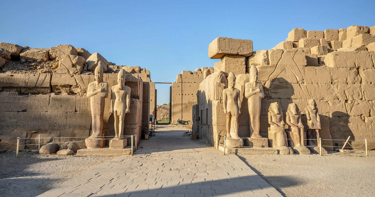 Amun-Ra statue and ancient Egyptian monuments at Karnak Temple in Luxor