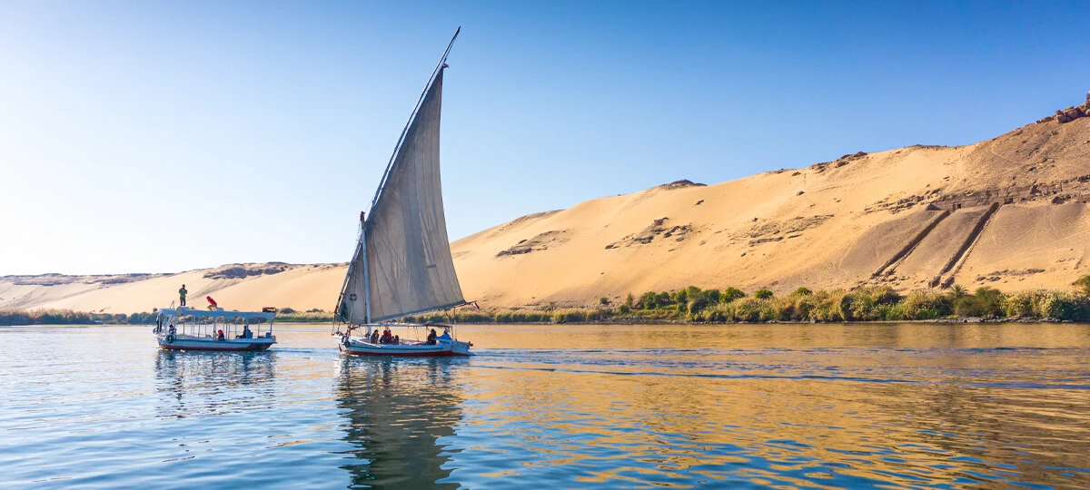 Traditional wooden felucca with a triangular sail on the Nile